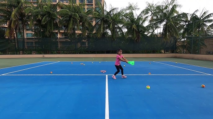 Kids enjoying a target-based tennis drill on a reduced court — keeping junior ball machine practice fun and engaging