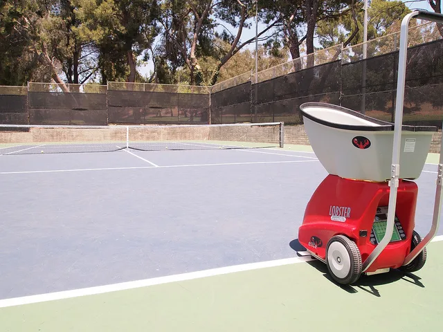 Player practicing forehand drills with a Lobster tennis ball machine rental in Singapore