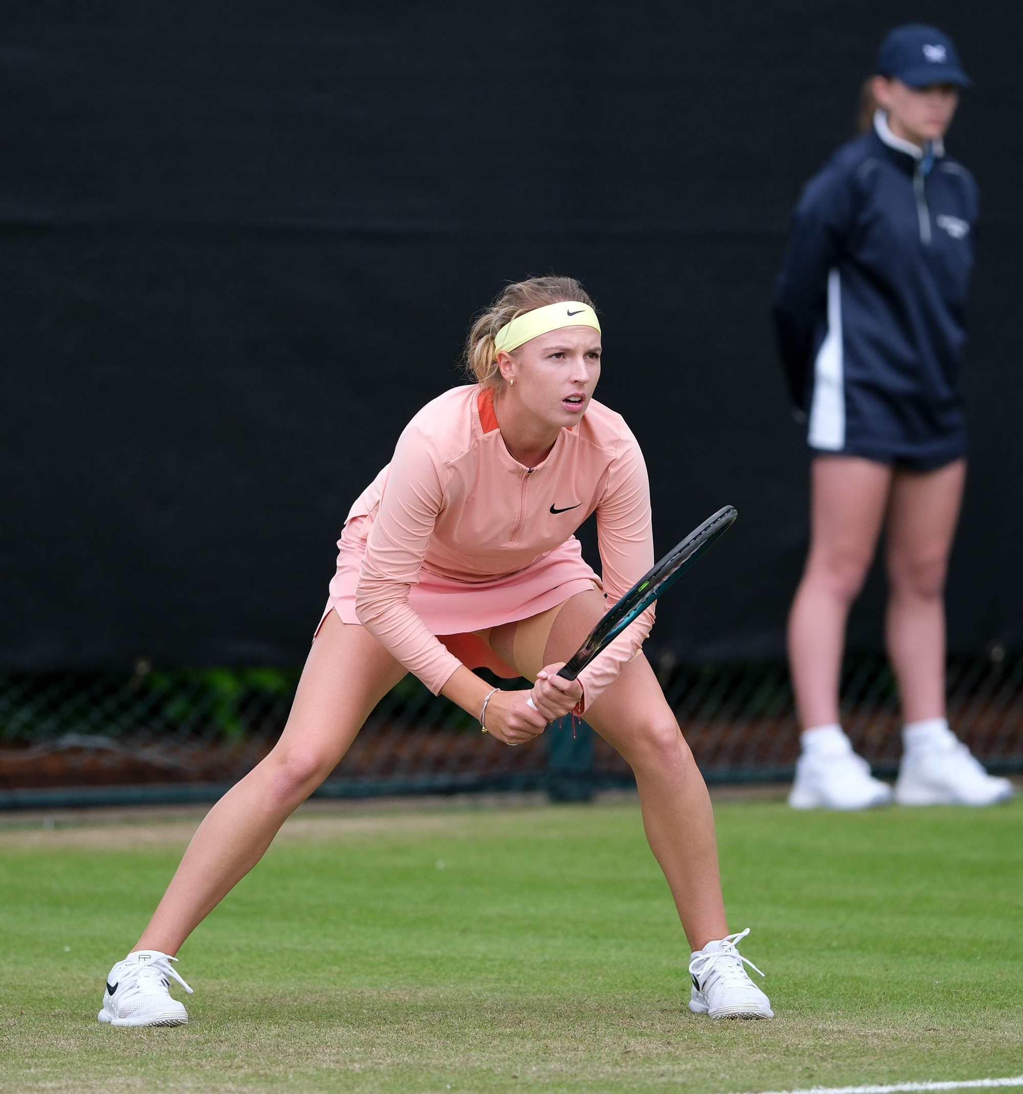 Player loading into a split-step to return a fast incoming ball — the footwork a tennis ball machine helps you groove for return of serve